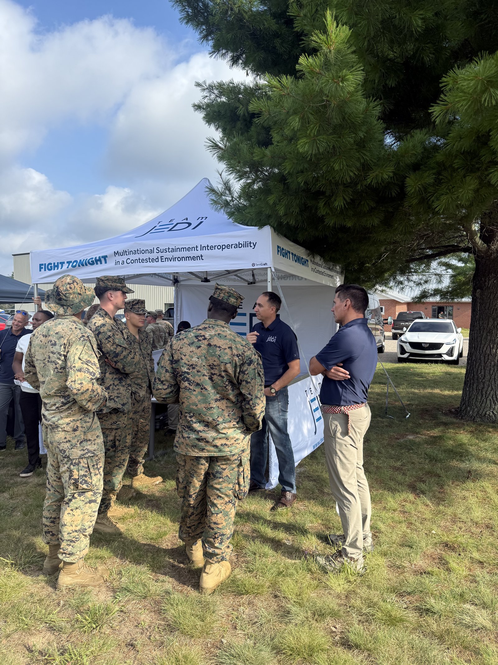 Marines and Team JEDI staff gathered outside the Team JEDI tent at Northern Strike 26